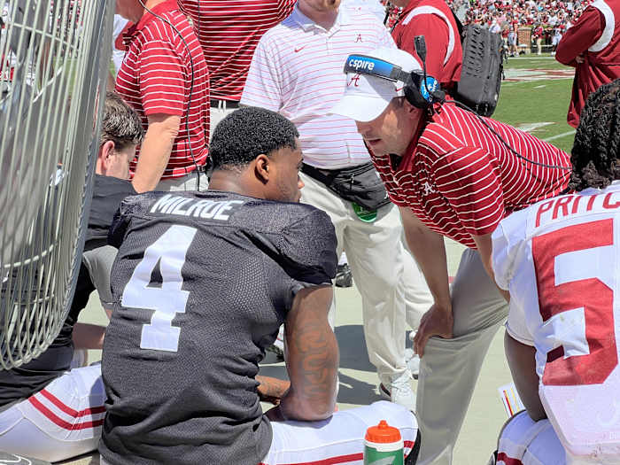Tommy Rees talks on the sideline with Jalen Milroe